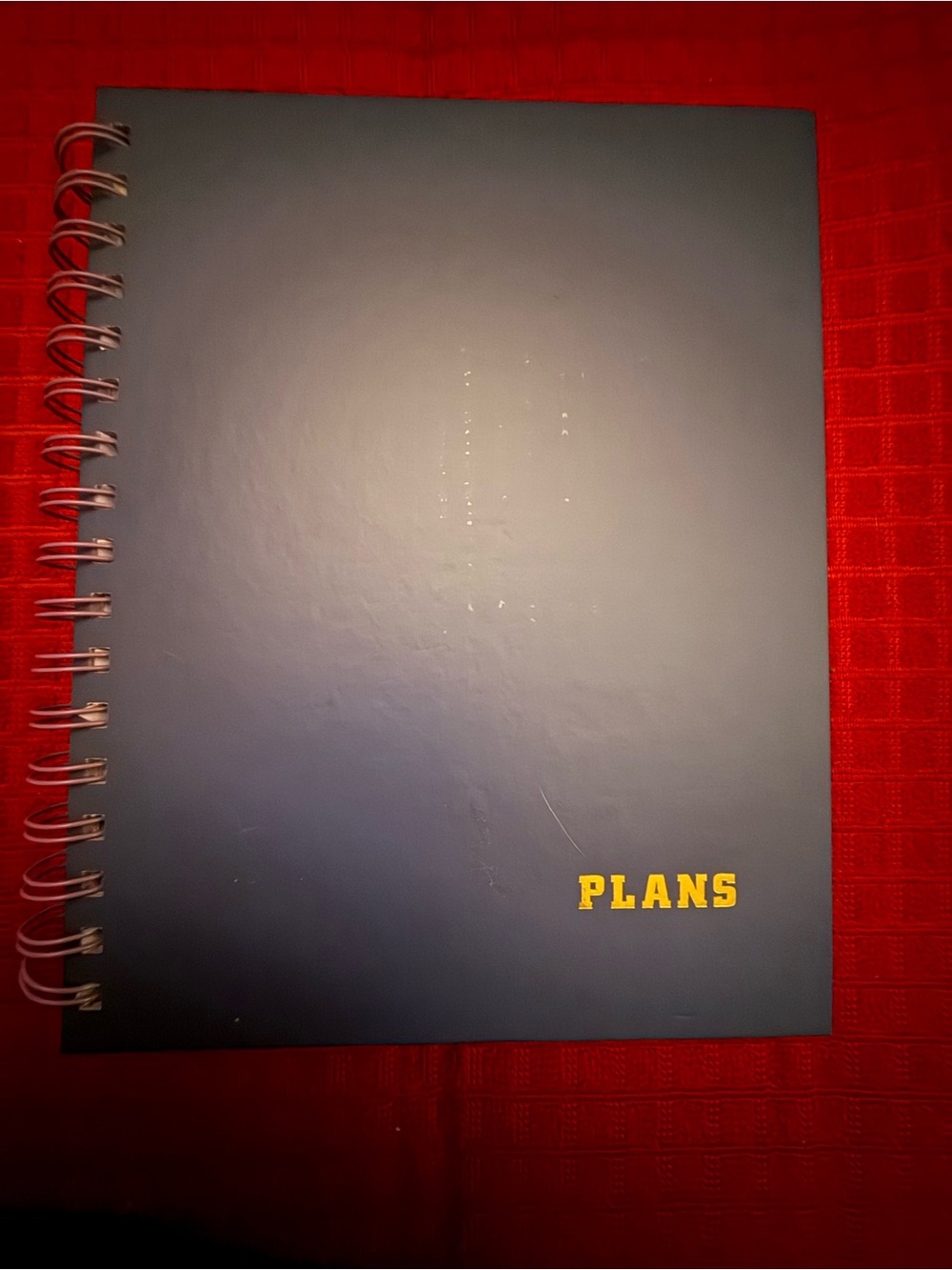 Navy Spiral Notebook with Yellow "PLANS" Cover